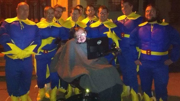 Stephen Hawking poses with a bunch of guys dressed as Bananaman for a bachelor party.