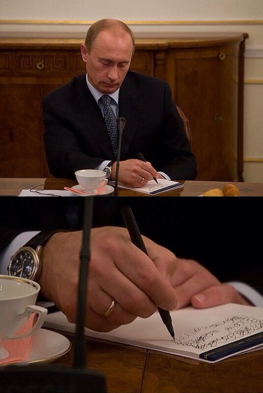 Vladimir Putin taking very detailed notes.