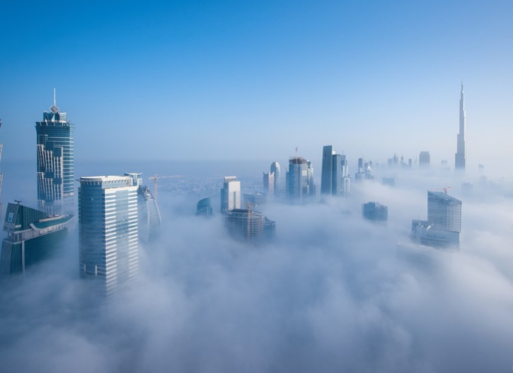 The city of Dubai with some of the highest skyscrapers in the world experiences this cloudy effect at the tops of their buildings twice a year when a heavy fog descends.