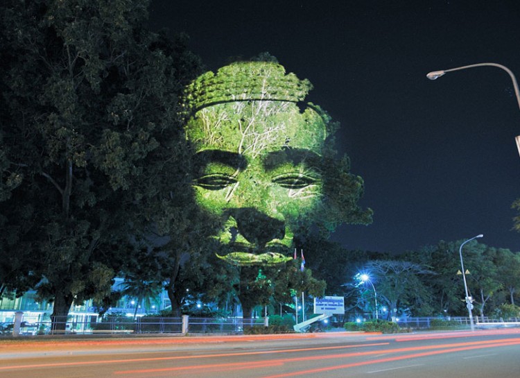 French artist Clement Briend is responsible for illuminating 3D faces onto trees with multiple large format projectors.