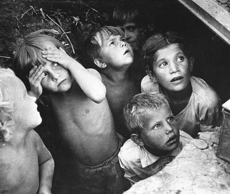 Children in Minsk, Belorussia watching as their neighborhood is bomed in June, 1941