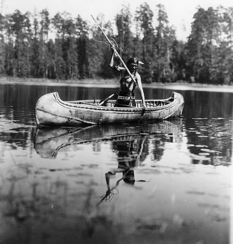 An Ojibwe Native American spearfishing in Minnesota in 1908