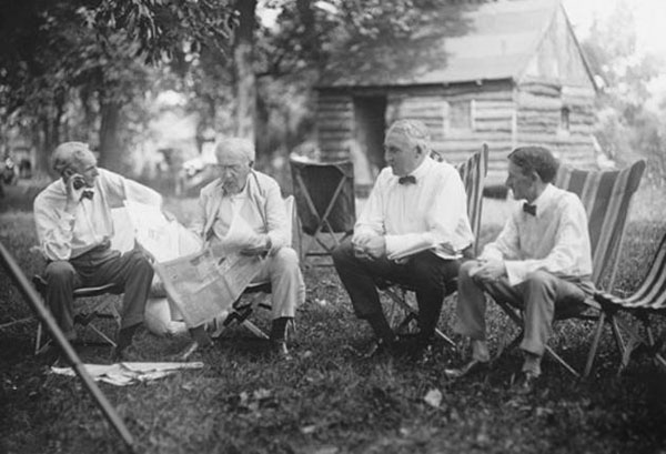 Henry Ford, Thomas Edison, Warren G. Harding (29th president of USA), and Harvey Samuel Firestone (founder of Firestone Tire and Rubber Co.) talking together