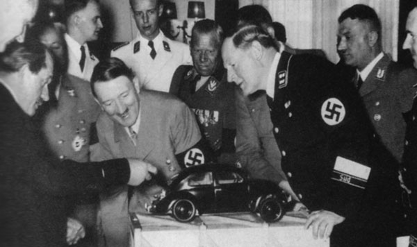 Ferdinand Porsche (yeah, that Porsche) showing a model of the Volkswagen Beetle to Adolf Hitler in 1935
