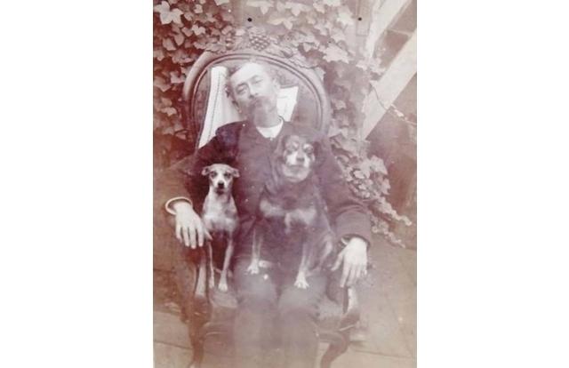 Death portraits often included the person's favorite things, like this sweet photo of a man with his dogs.