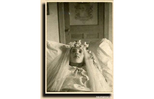 This young woman seems to have been photographed in her wedding veil.