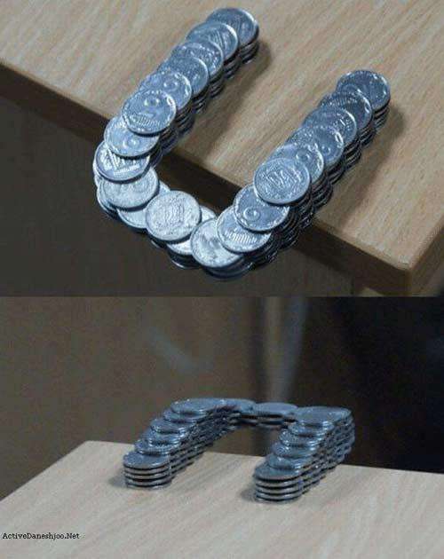 Coins stacks over the edge of a table