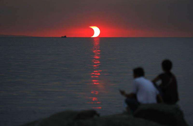 An eclipse and sunset happening simultaneously