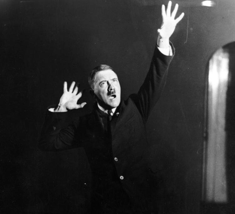 Hitler practicing his speeches while standing in front of a mirror in 1925