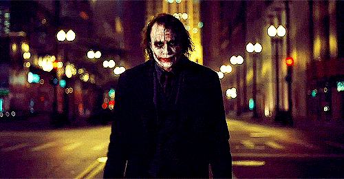 In the Dark Knight, Joker is portrayed to the audience the way that Batman is portrayed to criminals.

What do we ever find out about the Joker? Nearly nothing. He is a man with seemingly endless resources that arrived in Gotham, looked at the state of the city, decided that something must be done to change it, and so he offers his services to the criminals of the city. Not because he wants anything in return, but simply to "send a message". We never know what his real name is, where he got those scars, where he goes or what he does when he's not wearing the makeup.

This is almost exactly what Batman is to the underworld. A man who arrived out of nowhere with all these gadgets and vehicles, who decided that he could change the way that Gotham was by doing the work that the police wouldn't do, and thus "sending a message". And in the same way that the police turn on Batman, and have to condemn his actions, the criminals of Gotham eventually sell out the Joker.
The two are presented as two sides of the same coin. This is hammered home by the fact that two face is in the movie, a character who uses the same coin to make decisions about good and evil.