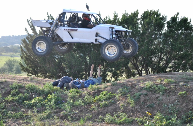 My stepdad is jumping over his three friends in his baja buggy...those three brave men....