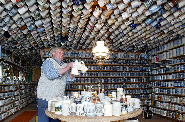 Heinrich Kath, a farmer, shows off some of his approximately 20,000 beer mugs in Cuxhaven, in northern Germany. Although he does not drink beer, he has been collecting steins since 1997.