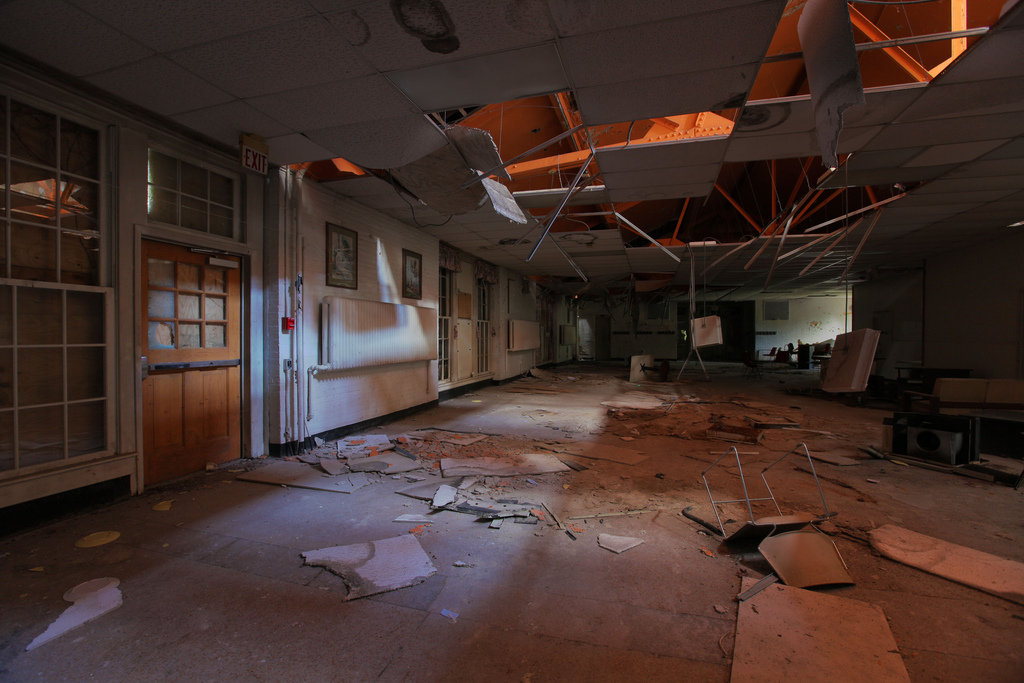 A dining hall is brought to light as its ceiling crumbles.