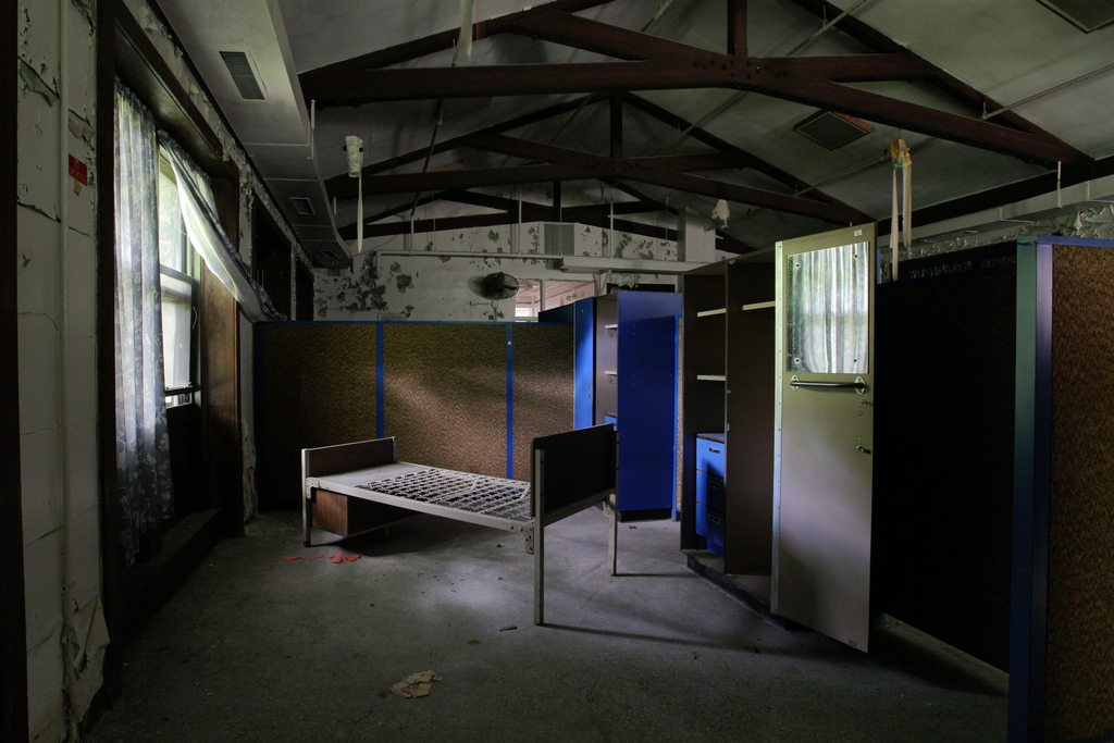 Inside a typical dormitory, some cubbies had four beds cramped within.
