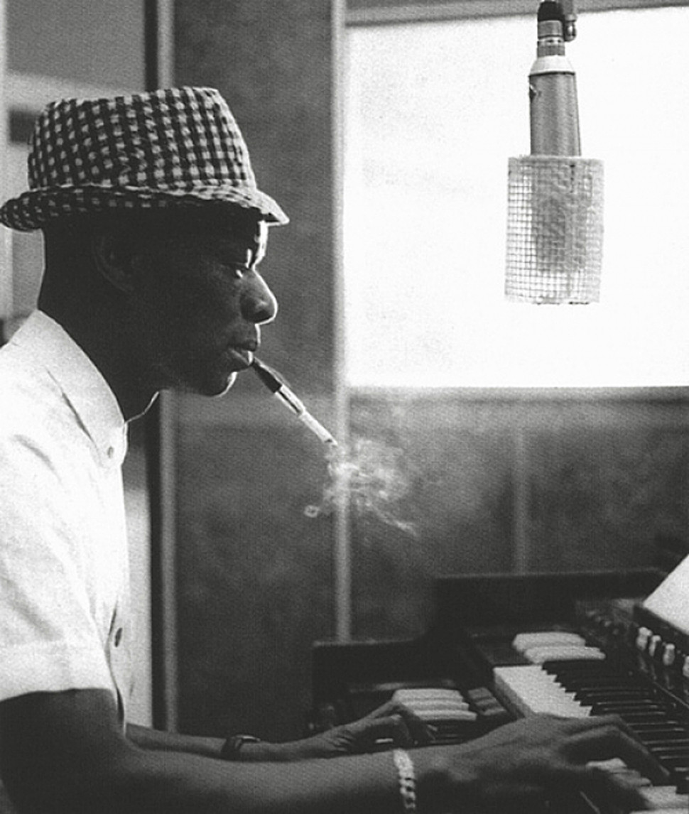 Nat King Cole plays piano.