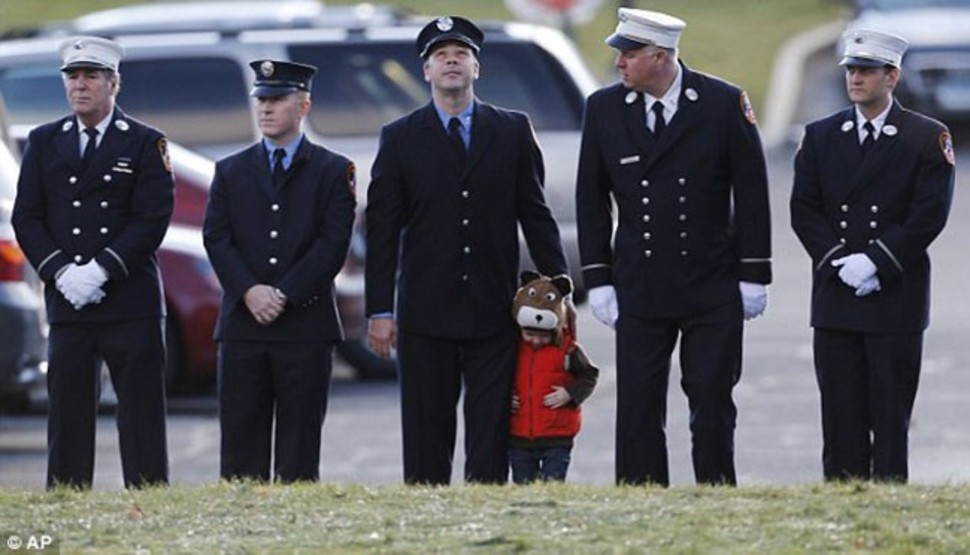 Firefighters line the streets during the funeral of seven year-old Daniel Barden, who dreamed of joining their ranks but whose life was cut short at Sandy Hook.