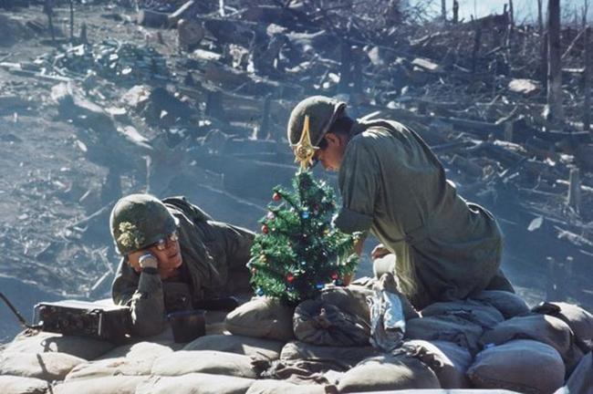 American soldiers on Hill 875 decorate a Christmas tree near Dakto, South Vietnam. 1967