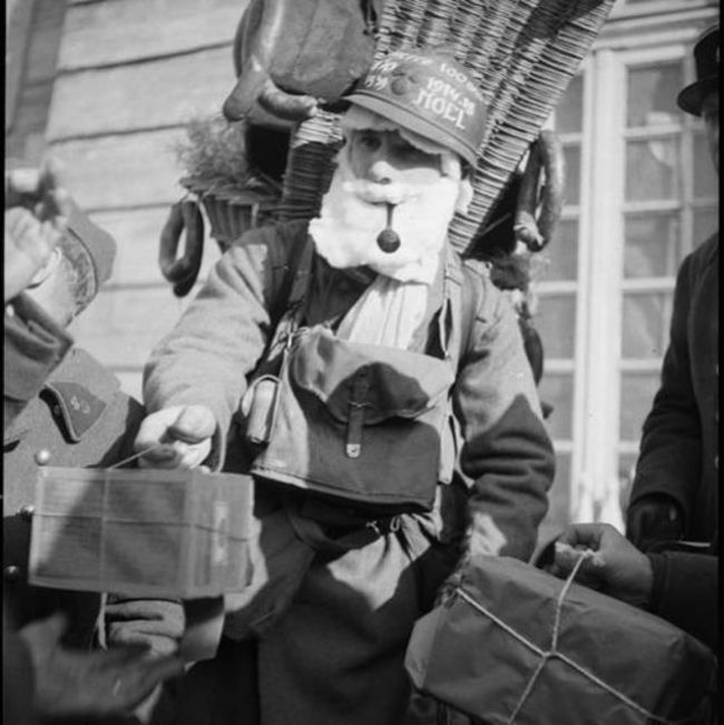 A French soldier, dressed as Santa, distributes parcels from home. 1939