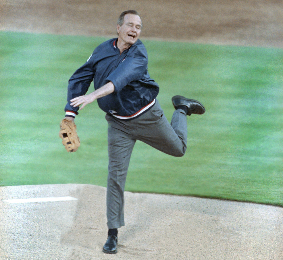 President George H. Bush throws the first pitch at the Texas Rangers' opening night in Arlington, Texas, April 8, 1991.