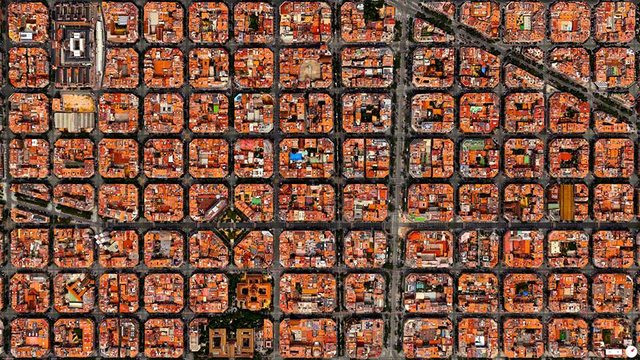 Eixample District Barcelona, Spain. Eixample - a district in the city of Barcelona, Spain - is characterized by its strict grid pattern, octagonal intersections, and apartments with communal courtyards.