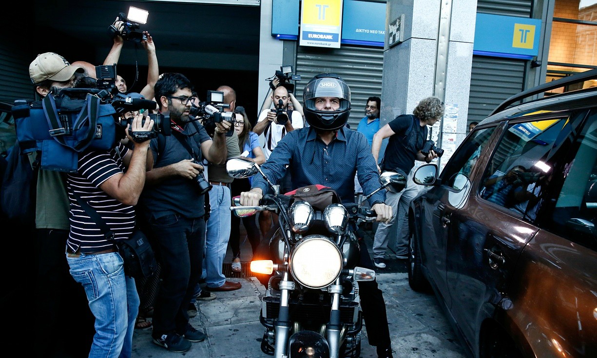On his bike: Yanis Varoufakis leaves the finance ministry in Athens.