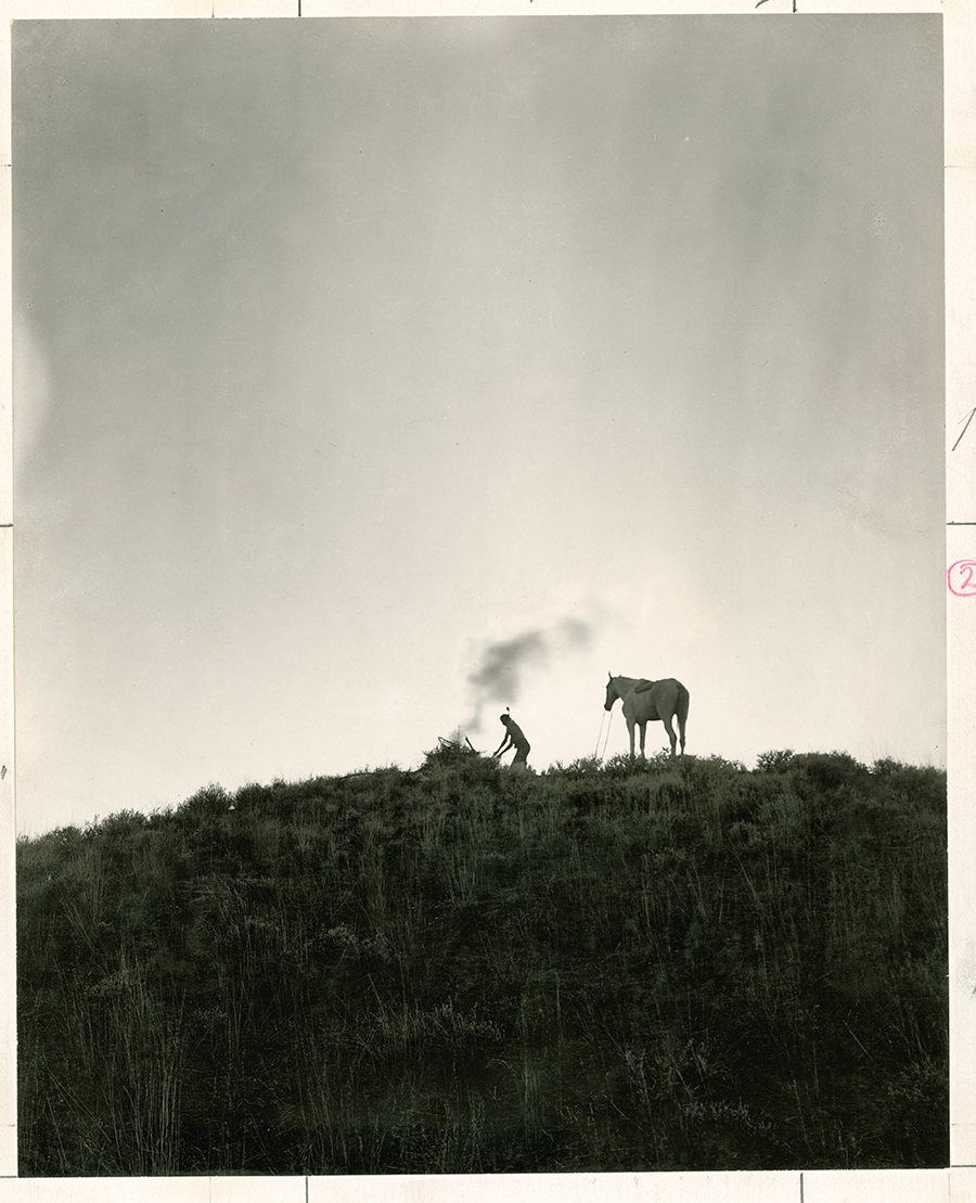 A Native American sends smoke signals in Montana, June 1909.