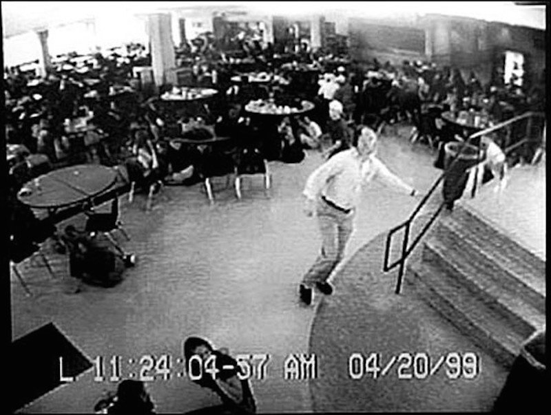 olumbine High School
This is a photo from the security cameras at Columbine High School during that tragic school shooting. The man shown is William David Sanders, a teacher there, and he warned students in the cafeteria of the shooting, which saved hundreds of lives but sadly not his own.