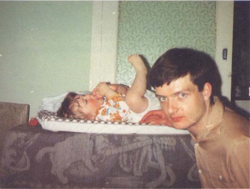 Ian Curtis
If you are unfamiliar with Ian Curtis, he was the singer for the 70’s rock band Joy Division. This photo is with his infant daughter and was taken five days before he committed suicide in 1980.