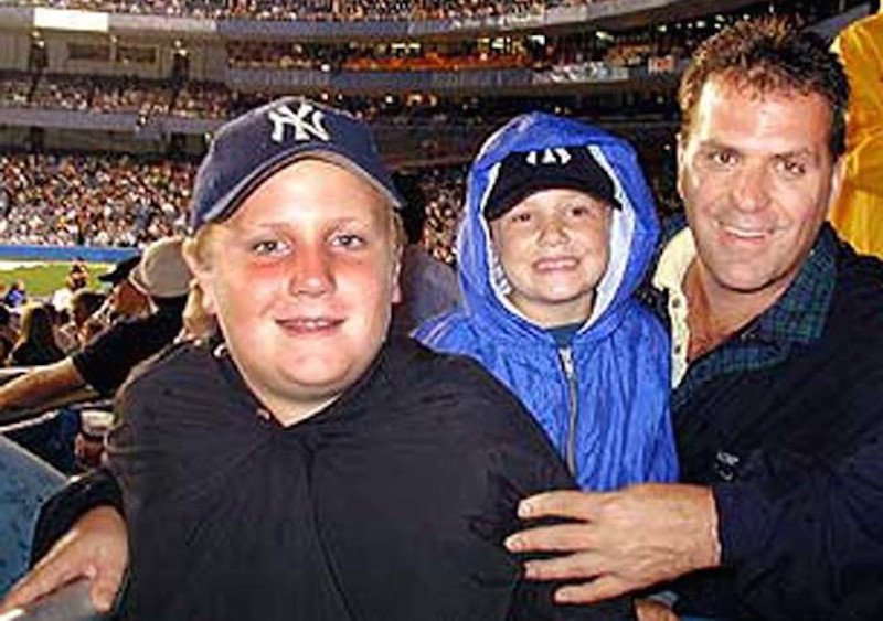 This image of Joe Kelly and his two sons was taken while they were at the New York Yankees game on September 10th, 2001. The following day, on September 11th, Kelly was tragically killed during the attacks on the World Trade Center.