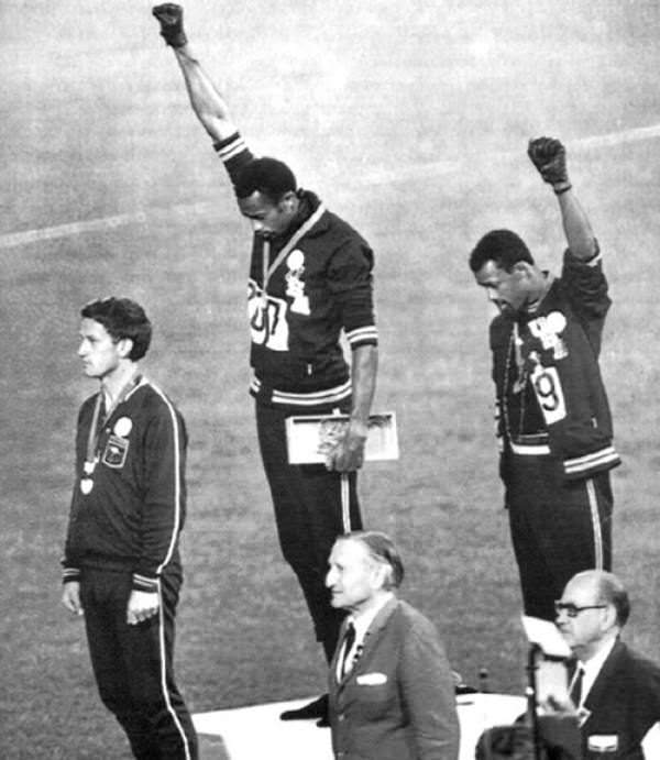 Bronze medal winner John Carlos raises a black power salute at the 1968 Mexico City Olympics.