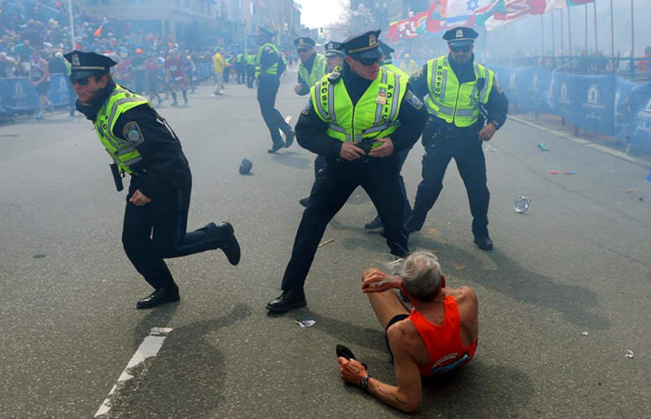 78-year-old Bill Iffrig lies on the ground following the 2013 Boston Marathon bombing.