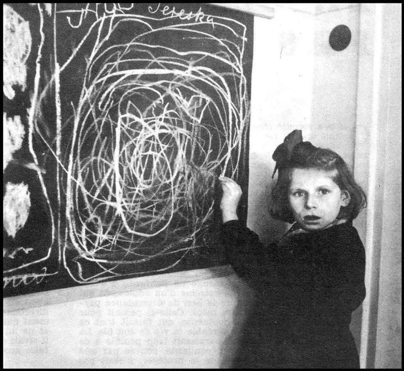 Terezka, a girl who grew up in a concentration camp, draws a picture of her Poland "home", December 1948.