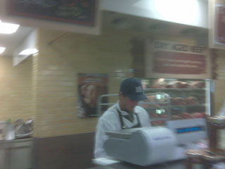 Cody Shaver works behind the counter of the meat department at Whole Foods.