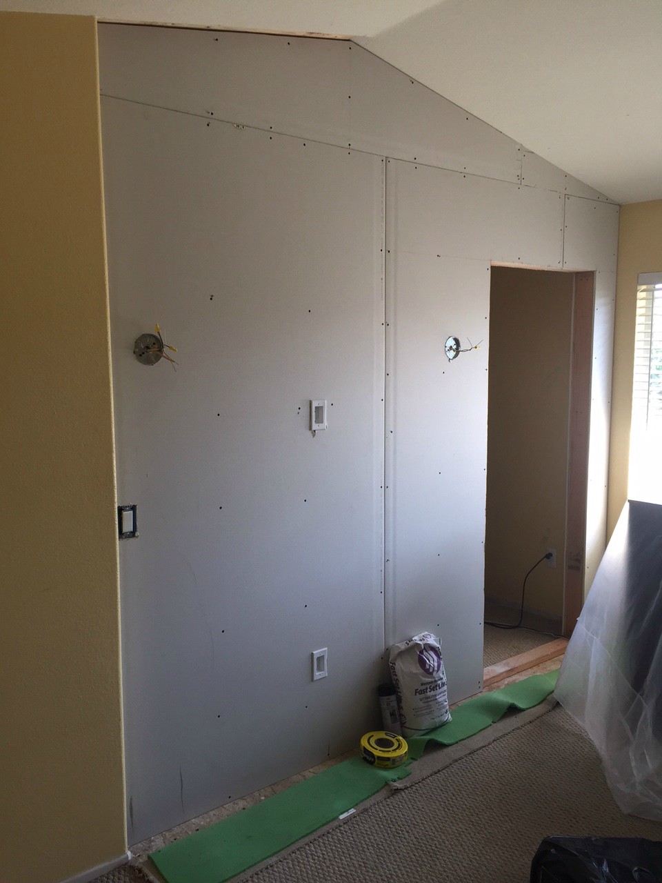 Cover the plywood up with dry wall. Don't for get about the electrical!