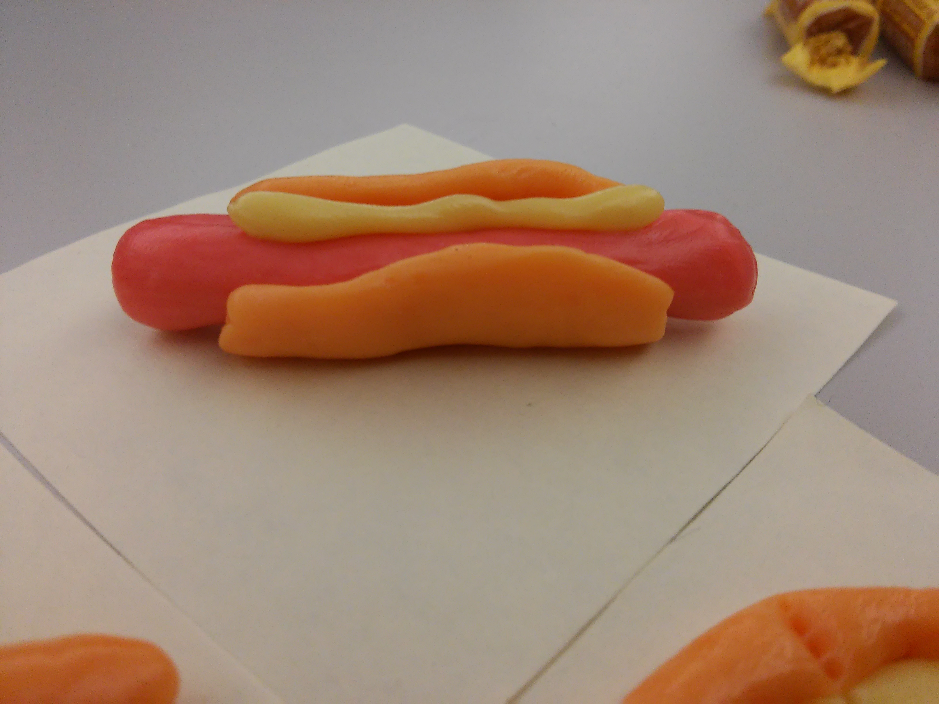 After a trade show with lots of fruit chews, someone figured out they were really malleable.  So a hot dog sculpture was made.  Which inspired coworkers to make....