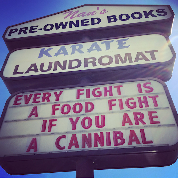 street sign - van s PreOwned Books Karate Laundromat Every Fight Is A Food Fight If You Are A Cannibal