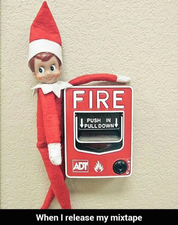 Elf on a shelf on a fire alarm