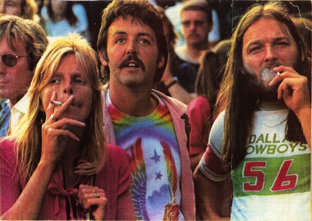 Linda and Paul McCartney and Pink Floyd’s David Gilmour attend Knebworth Fair in 1976. The Rolling Stones headlined the festival.