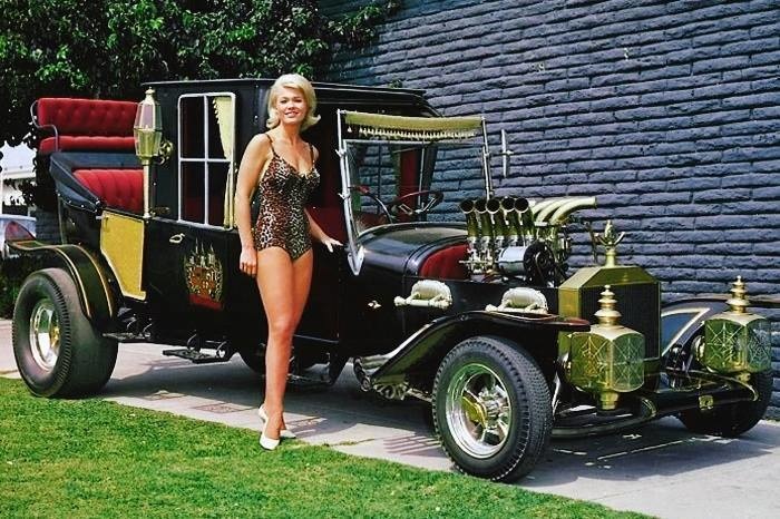 Actress Pat Priest as Marilyn Munster of The Munsters, posing with the Munster Coach.