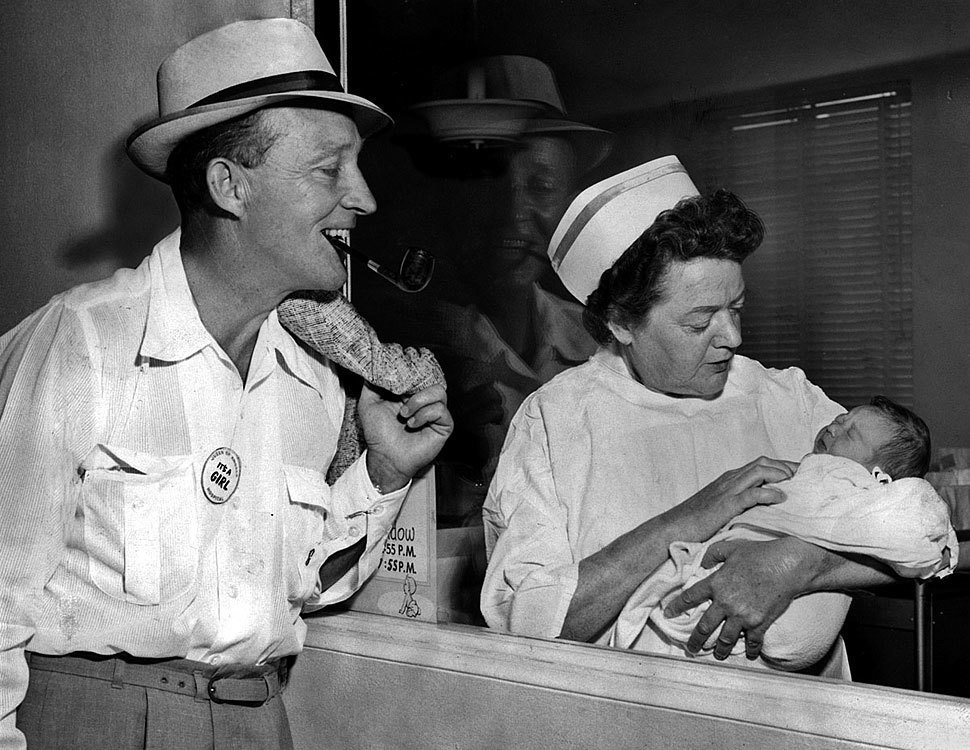 Bing Crosby and his newborn daughter, Mary Frances.