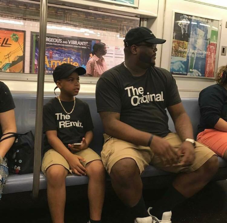 Big black dude on the subway wearing khaki shorts and shirt that says The Original and his kid next to him dressed exactly the same way with a shirt that says The Remix.