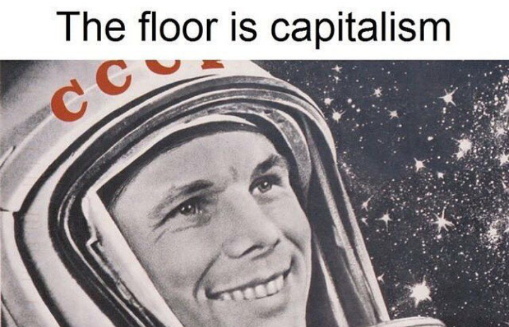 Meme of a Russian cosmonaut smiling in space with a caption 'The Floor is Capitalism'