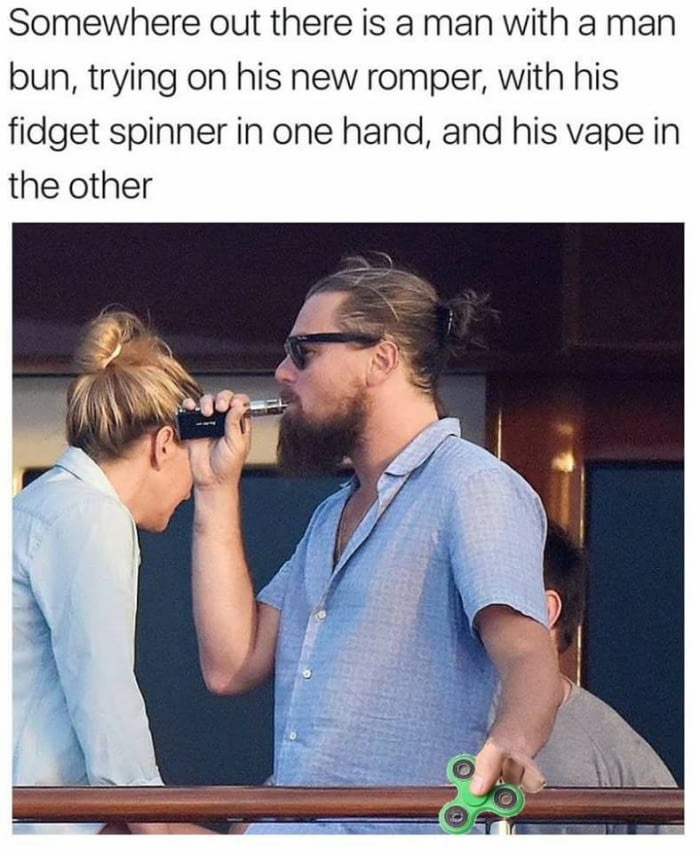 Meme of Leonardo DiCaprio as that man out there, wearing a man bun, trying on his new romper, with his fidget spinner in one hand, and his vape in the other.