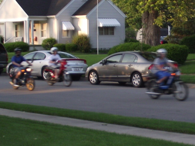 A gang of kids on mopeds