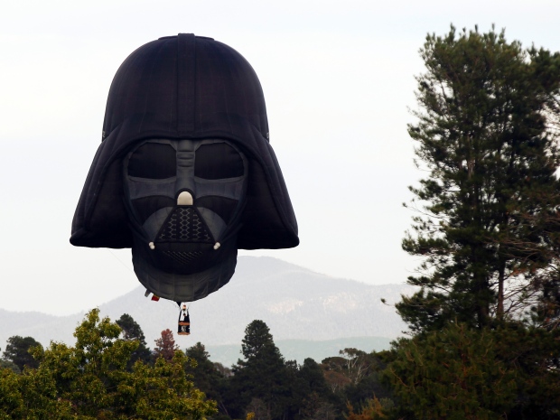 A hot air balloon shaped like Darth Vader's head floats over Canberra in March.