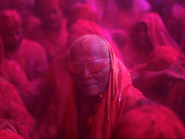 A Hindu devotee peers out from a cloud of coloured powder during the Lathmar Holi festival in the village of Barsana in the northern Indian state of Uttar Pradesh in March.