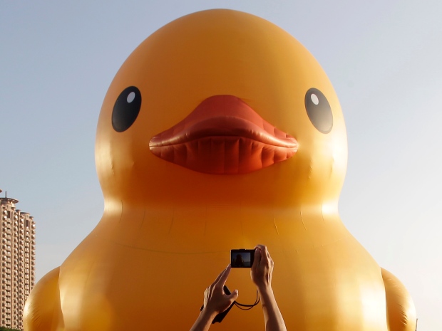 The Rubber Duck by Dutch conceptual artist Florentijn Hofman floats in Kaohsiung Harbour in southern Taiwan, in September. The giant rubber duck, which is 18 metres high and weighs 1,000 kilograms, made its first public appearance in Taiwan before being set up in cities around the world.