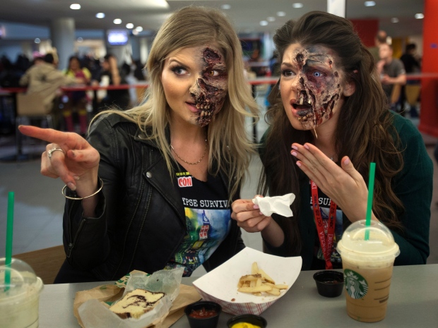 Clad in zombie makeup, artists Kamila Wysocka and Alexis Jackson, from Florida, enjoy a spot of people watching over dinner at ComicCon in New York, in October.