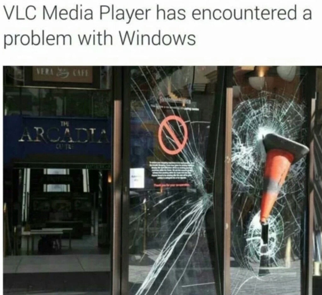 Traffic cone stuck in a window with joke that it is a VLC Media Player has encountered problems with Windows