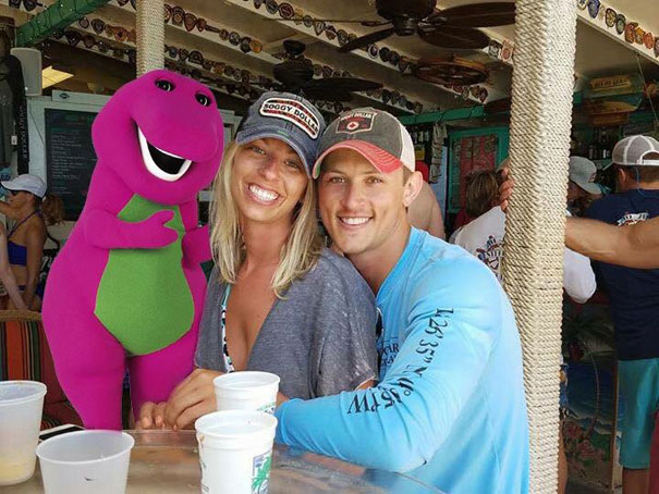 Barney the dinosaur photoshopped over fat dude in couple that got engaged picture.